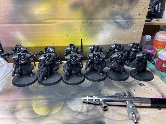 Two squads of 6 Cataphractii terminators on a makeshift airbrush station, primed in black.