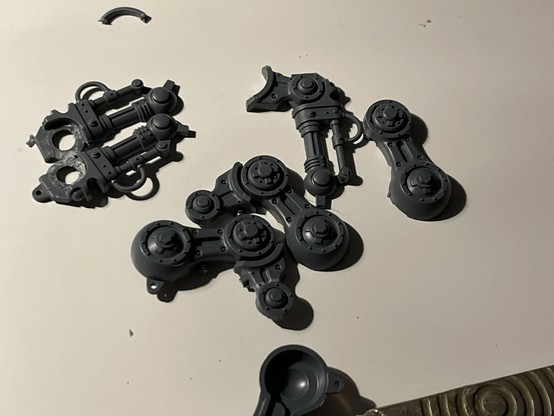 Some Warhammer model parts, the legs of an Armiger knight partially cut so that they can be repositioned.