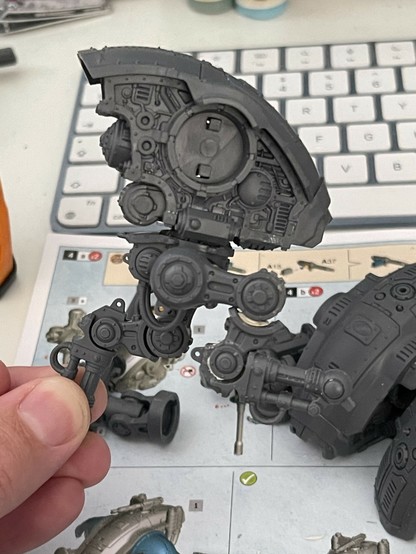 A partially constructed Warhammer Armiger model in a running pose. Shown from the side to show the construction of the repositioned leading leg.